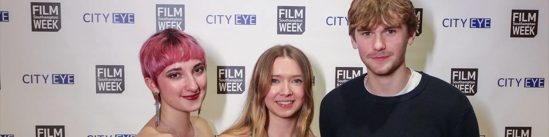 Sasha Sinkler, Helen Burdfield and Harvey Cecil stood in front of a Southampton Film Week banner.