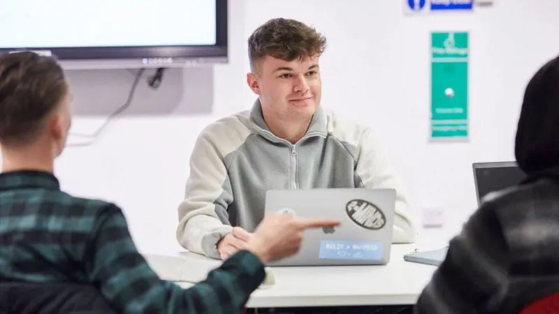 A business student with a laptop
